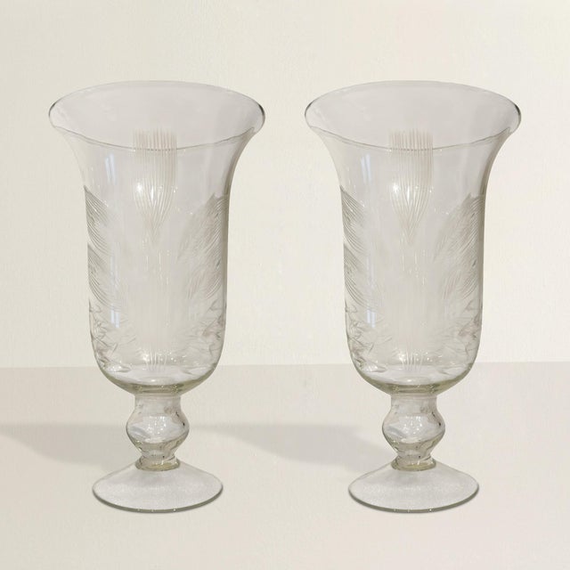 Graceful, luminous, and quietly poetic, this pair of blown glass hurricanes brings a gentle sense of ceremony to the...