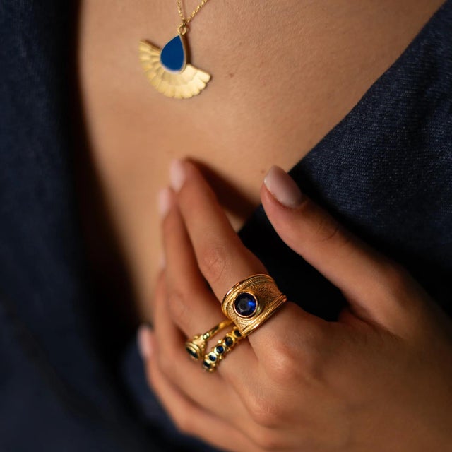 Step into timeless elegance with the Majestic Sapphire Gold Statement Ring, a bold and regal piece designed to make a...