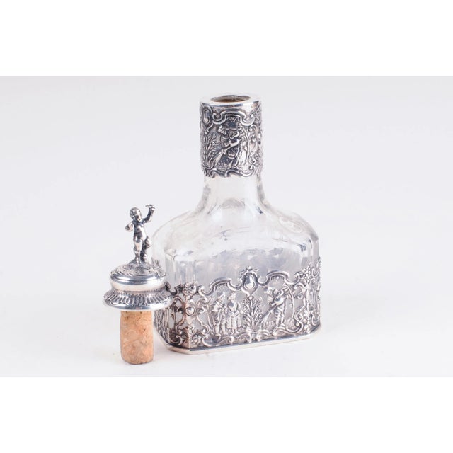 Storck & Sinsheimer (1874-1926) Hanau, Germany Silver (.800). Marked on bottom. Mounted and cut-glass silver decanter....