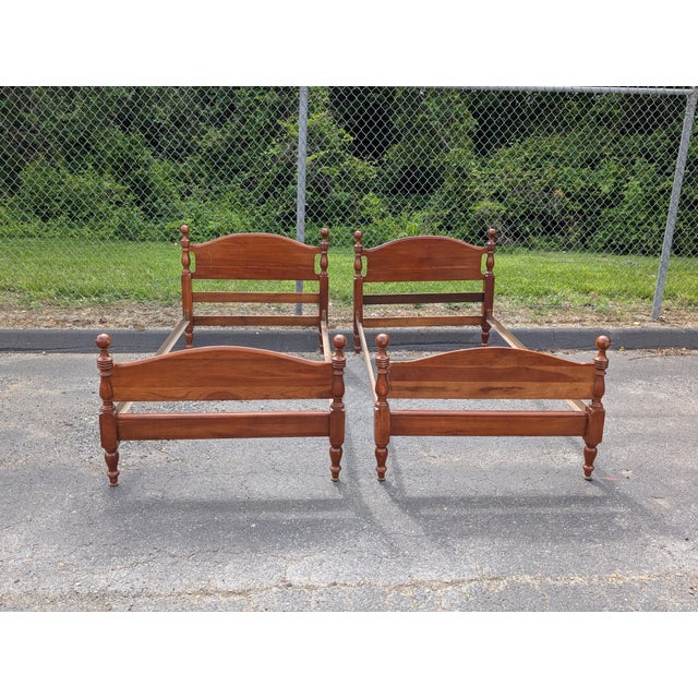 A Matching Set of Carved Cannonball Cherry Twin Bedsteads. Exquisite craftsmanship defines this pair of American Colonial-...