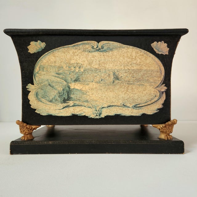 Beautifully wooden box with golden paws and a painting of a house on hills on both sides. It makes perfect catchall,...