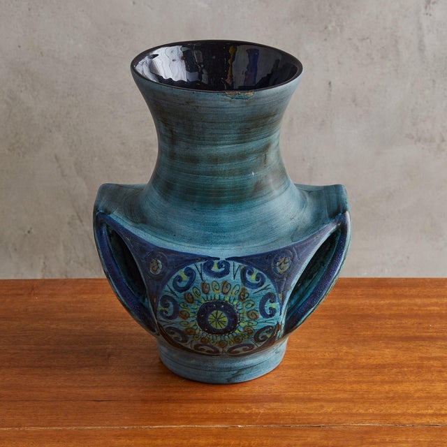 A 1960s French ceramic vase by Jean de Lespinasse. This sculptural piece features a rich blue glaze with hand-painted...