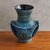 A 1960s French ceramic vase by Jean de Lespinasse. This sculptural piece features a rich blue glaze with hand-painted...