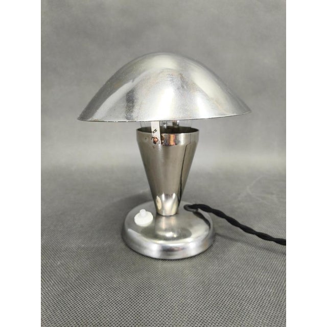 Classic Bauhaus table lamp from 1930s Czechoslovakia, defined by its clean geometry and practical design. The lamp...