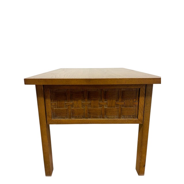 A Mid-Century Modern end table from Lane. This piece features the signature basketweave drawer front, adding both texture...