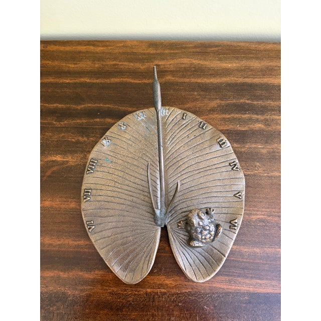 A stunning vintage iron garden sundial featuring a charming frog on a lily pad USA, Late 20th Century Measures: 8.5"W x...