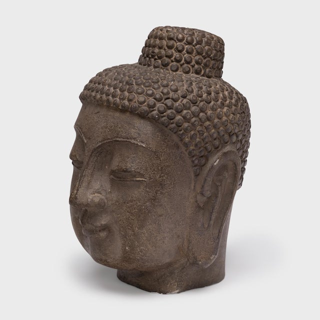 With closed eyes and a gentle expression, this large stone Buddha head brings calm and serenity to its surroundings. The...