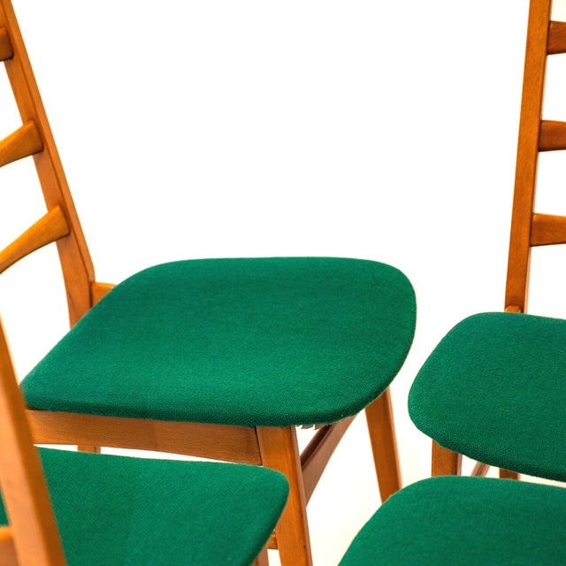 Continuation of 4 wooden dining chairs in Scandinavian style, seated covered with its original green fabric. In very good...