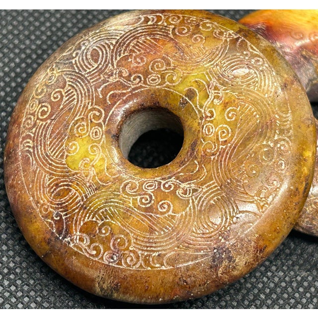 Vintage Chinese Hongshan Style Carved Jade Bi Discs Set of Three This curated collection features a magnificent trio of...