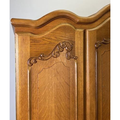 This elegant Vintage French Louis wardrobe showcases graceful French styling with beautifully sculpted decorative panels...