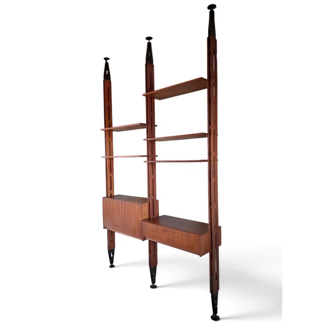 This wall unit with floor-to-ceiling uprights, attributed to Franco Albini's design for Italian production in the 1960s,...
