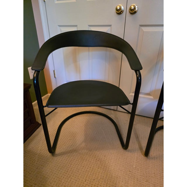 pair of Vintage 1970s/80s canasta cantilever chairs, Made in Italy with black leather seats and backrest on a black steel...