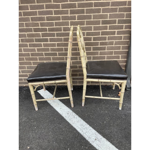 Love these faux bamboo chairs. Neutral paint finish with deep brown leather seats with brass nail head detail. Very Billy...