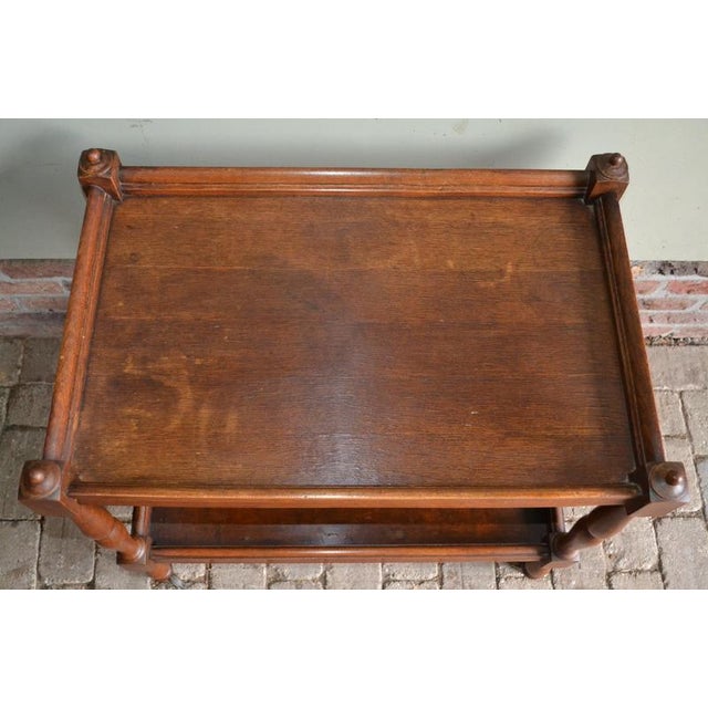 19th century English oak wooden tea trolley. The height is 68 cm. The width is 45 cm. The depth is 70 cm. with two floors....