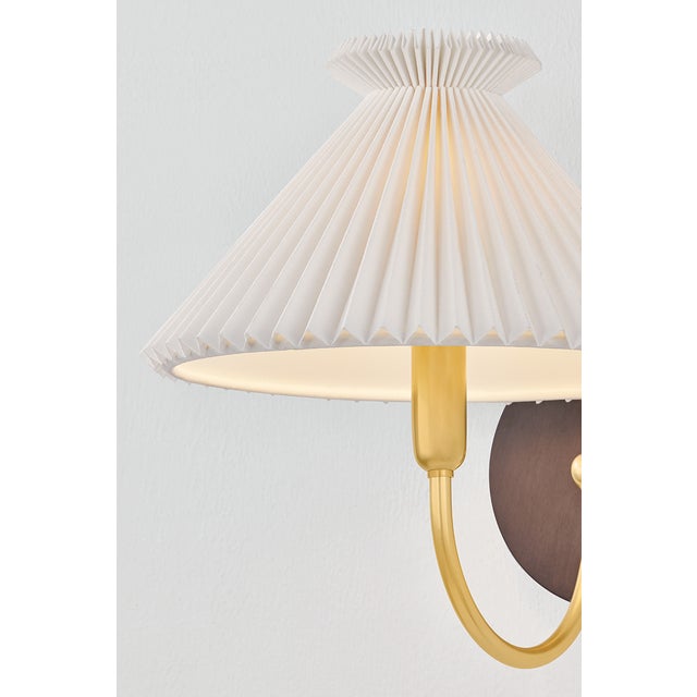 The Acacia sconce is playfully maximalist in form, yet tailored in materiality. The white linen shade has a sophisticated...