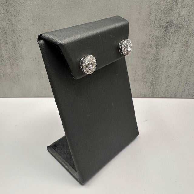 These stunning natural diamond stud earrings are set in 14kt white gold and feature approximately 0.90ctw of HI color, SI...