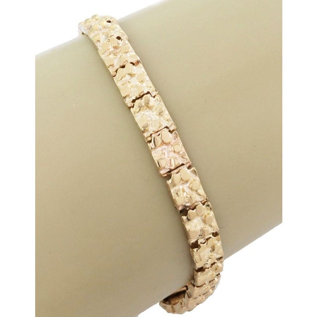 This authentic nugget rectangular link bracelet is crafted in solid 14k yellow gold and showcases a timeless vintage...