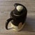 A sculptural vintage ceramic teapot featuring an abstract hand-painted design in rich chocolate brown and warm cream tones...