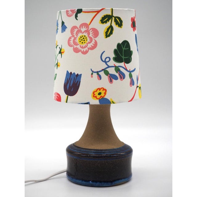 A Handmade rare ceramic stoneware table lamp with shimmering beautiful blue glazing. The blue glazing picks up the colors...