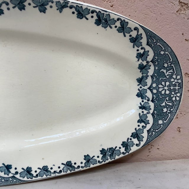 French faience blue and white fish platter signed Longwy, circa 1900. Measures: 21.5" L x 8.5" W x 1.5" H.