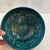 Hand blown art glass bowl in swirls of greens and blues with mixed colors on the exterior. Very attractive and takes on...