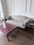 A stately three-seat sofa with a richly carved dark mahogany frame, cream-and-gold floral damask upholstery, and elegant...