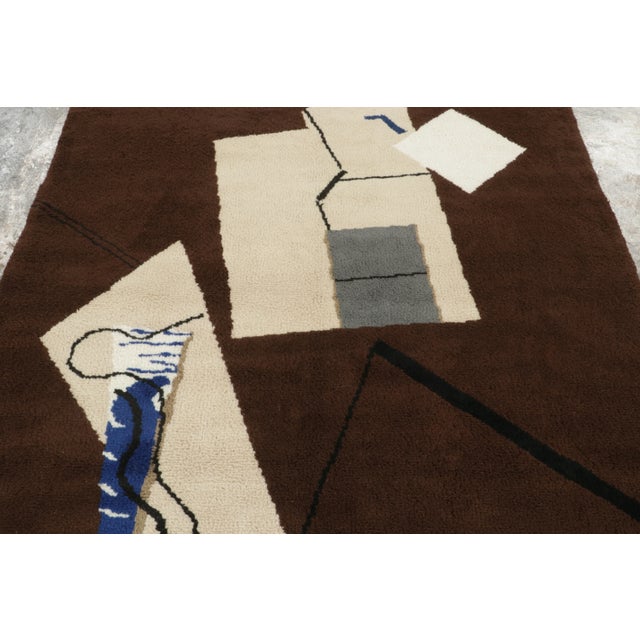 This 5x7 French Mid-Century Modern rug inspired by Eileen Gray is handwoven in wool, showcasing a bold abstract design of...