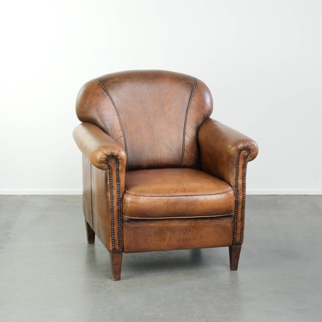 This characterful sheepskin armchair features a comfortable seat and a beautiful patina. The armchair has a fixed seat...