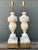Elevate your interior with this exceptional pair of vintage Neoclassical table lamps, masterfully hand-carved from genuine...