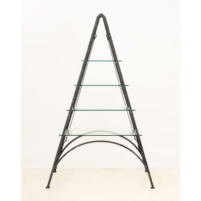 Mis en Demeure "Bibliotheque Hastings" Etagere, iron pyramidal structure with four glass shelves. 79.5" H x 49.5" W x...