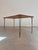This dining table from the 1960s perfectly embodies mid-century minimalism, captivating with its wonderfully understated,...