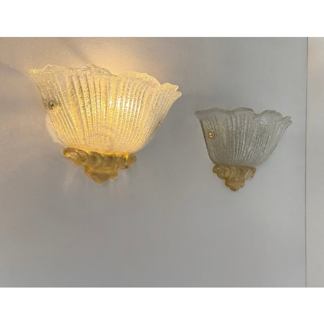 Pair of wall sconces made of pressed, molded Murano glass, produced in Italy in the 1980s. Several pairs available....