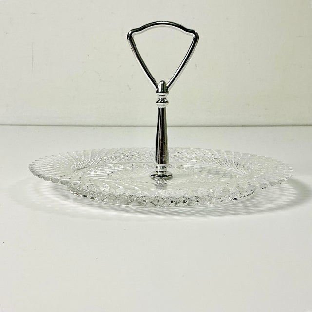 This is a lovely diamond point glass Bon Bon plate with a silver metal center handle. The Diamond Point design was...