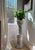 Elegant pair of substantial solid marble pedestals featuring beautifully carved spiral-fluted columns, intricate floral...