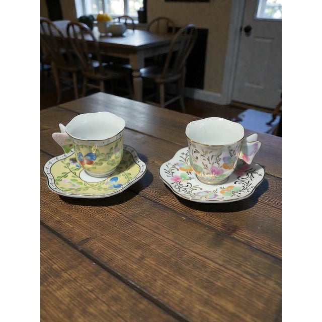 The Formalities Baum Brothers Floral Butterfly Handle Demi-Tasse Cup & Saucer Pair is a beautifully designed set of...