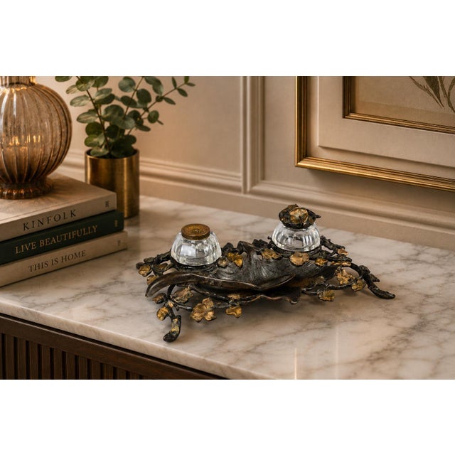 French Art Nouveau inkstand dating to circa 1900, made from bronze-toned metal with two glass inkwells. Trailing ivy...