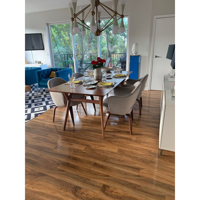 Jonathan Adler Caracas 16-light chandelier with an antique brass frame, black powder-coated cones, and white acrylic globe...