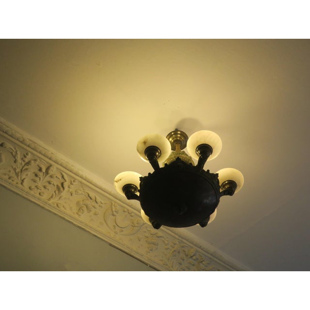 Large and impressive antique bronze chandelier with six lights in veined alabaster shades, finely worked bronze...
