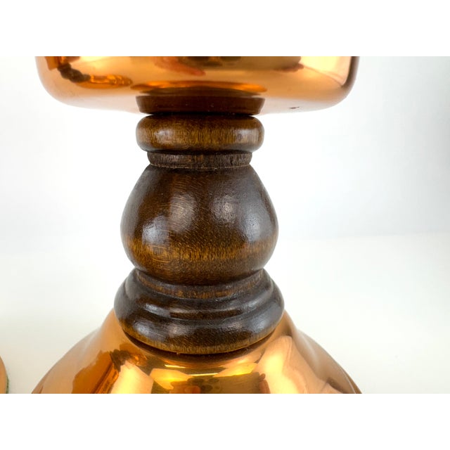 A pair of vintage Coppercraft Guild candlesticks featuring warm polished copper bodies accented with richly toned turned...