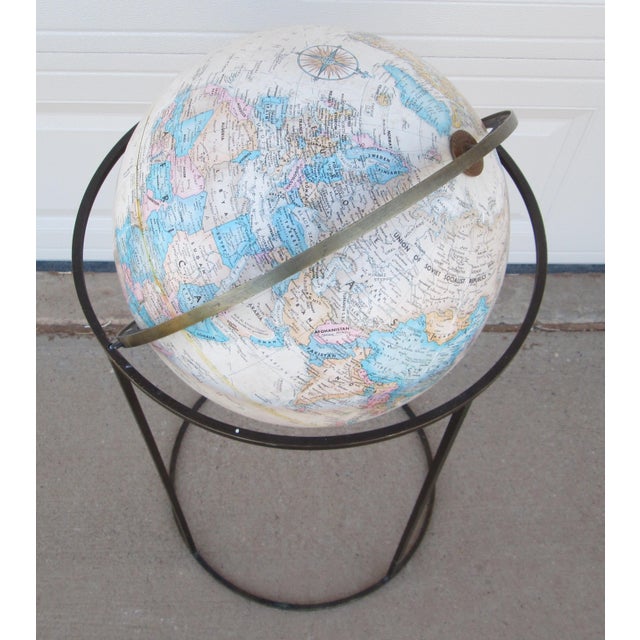 Vintage Mid Century Modern Brass stand floor globe in the style of Paul McCobb. The stand is made of angled brass bar the...