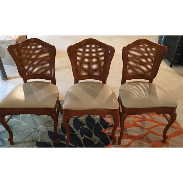 Lovely and sturdy wooden table with washable veneer square top and vinyl seat covers for the matching 3 cane-back chairs,...
