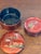 A striking mid-20th-century Japanese lacquerware coaster set featuring six individually decorated coasters housed in their...