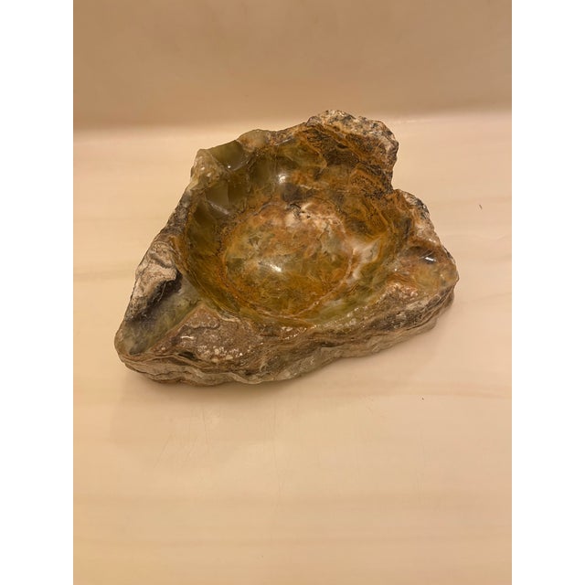 This is a vintage green stone ashtray, likely made of onyx, agate, or alabaster, with a rugged, natural-rock exterior and...
