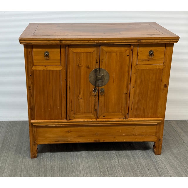 Design Plus Gallery presents an Elmwood Cabinet + Hidden Storage Compartment. The vintage wood cabinet has a warm honey-...