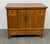 Design Plus Gallery presents an Elmwood Cabinet + Hidden Storage Compartment. The vintage wood cabinet has a warm honey-...