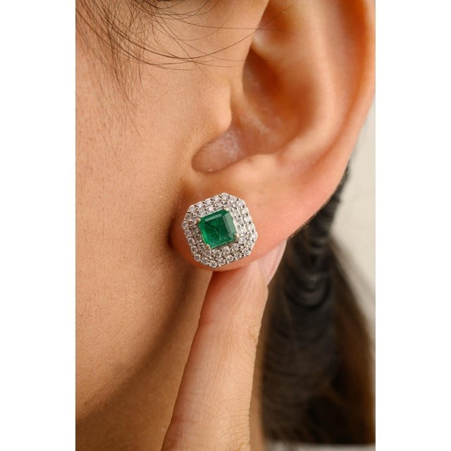 This is part of Chairish’s Fine Jewelry assortment. These exquisite stud earrings feature vibrant emeralds at the center,...