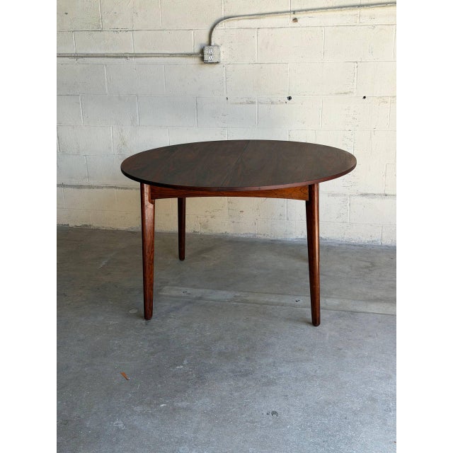 Beautiful vintage Danish Mid-Century Modern round dining table crafted in richly figured rosewood veneer with dramatic...