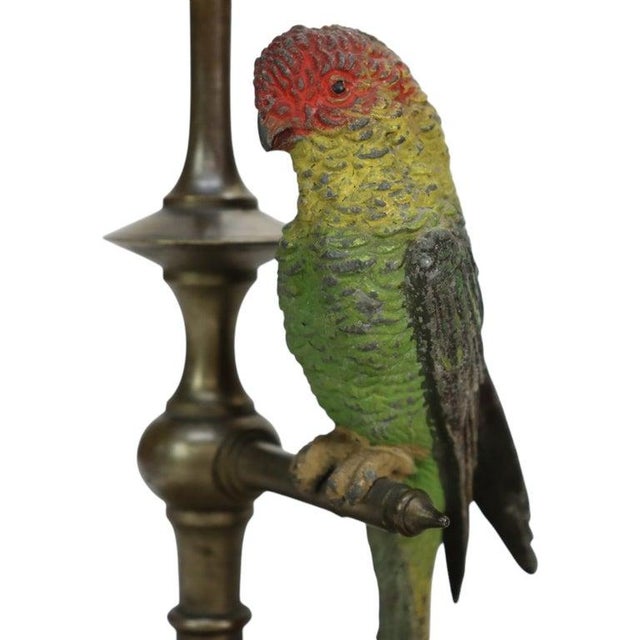 Pair of antique brass candlesticks with cast, cold-painted parrot figures, identified as Bergman bronze and dated circa...