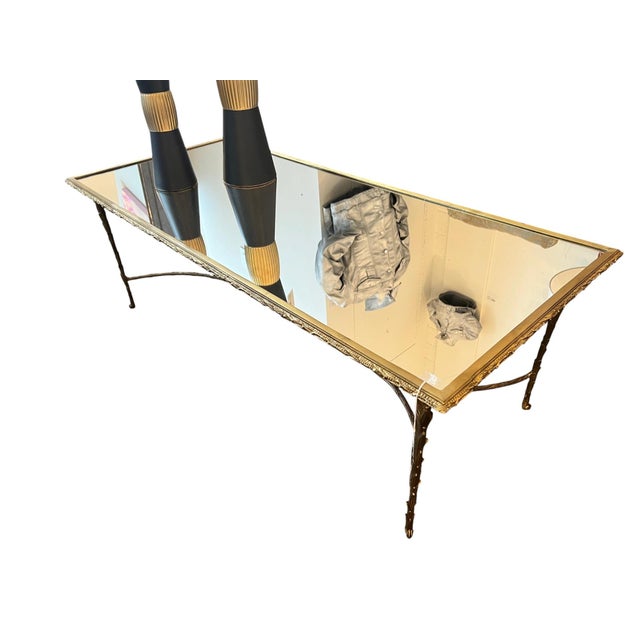 An elegant Maison Bagues style cocktail table featuring a beautifully sculptural gilded bronze organic base supporting a...