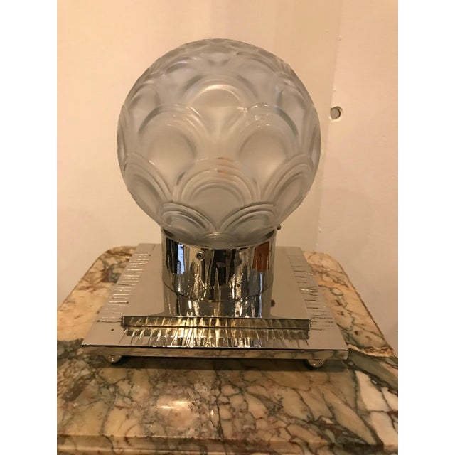 French Art Deco table lamp by Pierre D’avesn. The shade is enhanced by geometric motif in clear frosted glass with...